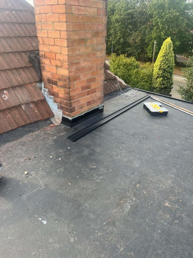 This is a photo of a flat roof which has just been repaired, there is also a chimney stack and some leadwork has also been dressed. Works carried out by LS Roofing Henley-on-Thames